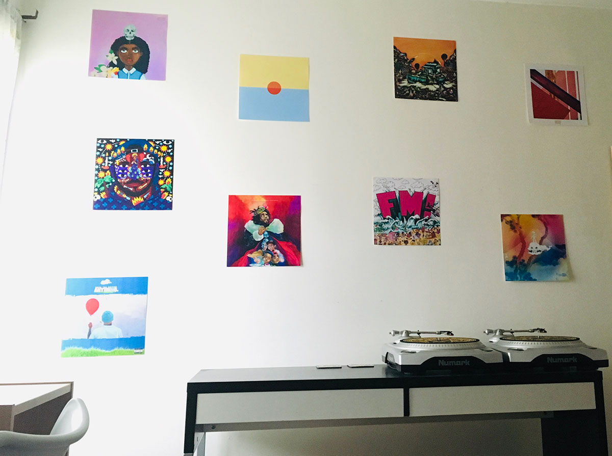 album cover print outs on a wall